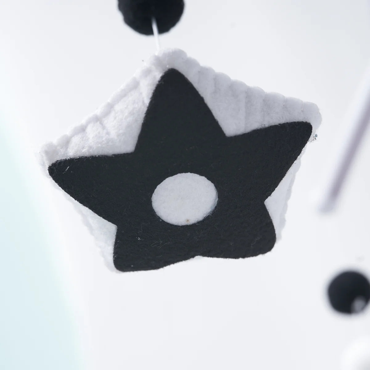 Hand-stitched black-and-white felt star detail