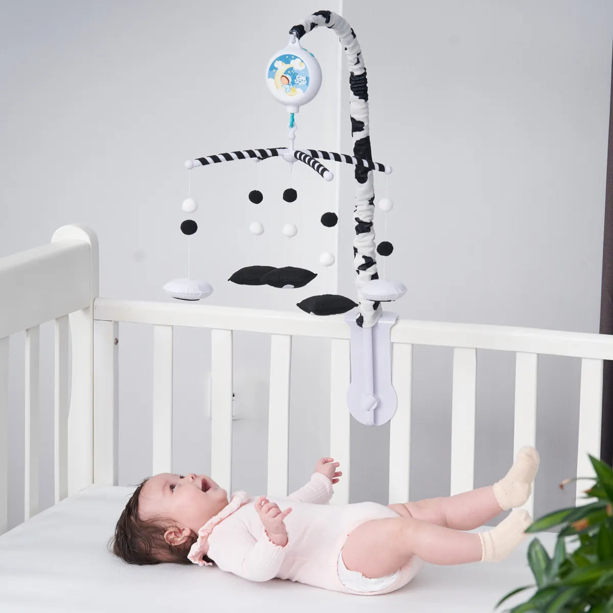 Black-and-white Animal mobile positioned above a baby’s crib