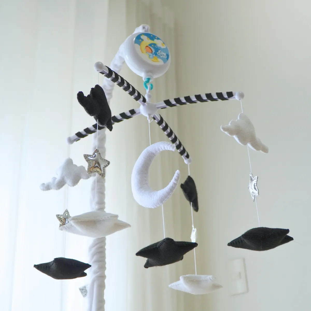 Moon & Stars mobile with crib arm and music box mounted above the crib