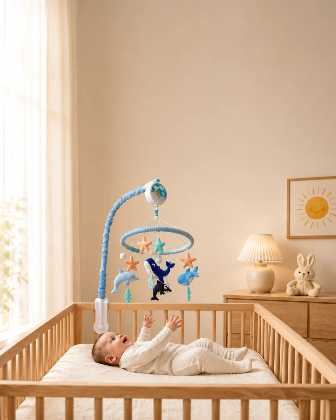 Baby enjoying a Tinitigies nursery mobile in a cozy nursery room