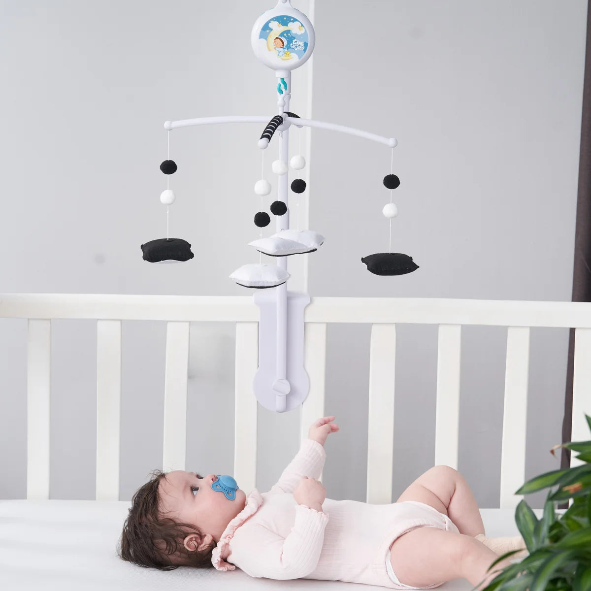 Geometry mobile above a crib, with shapes facing down toward baby
